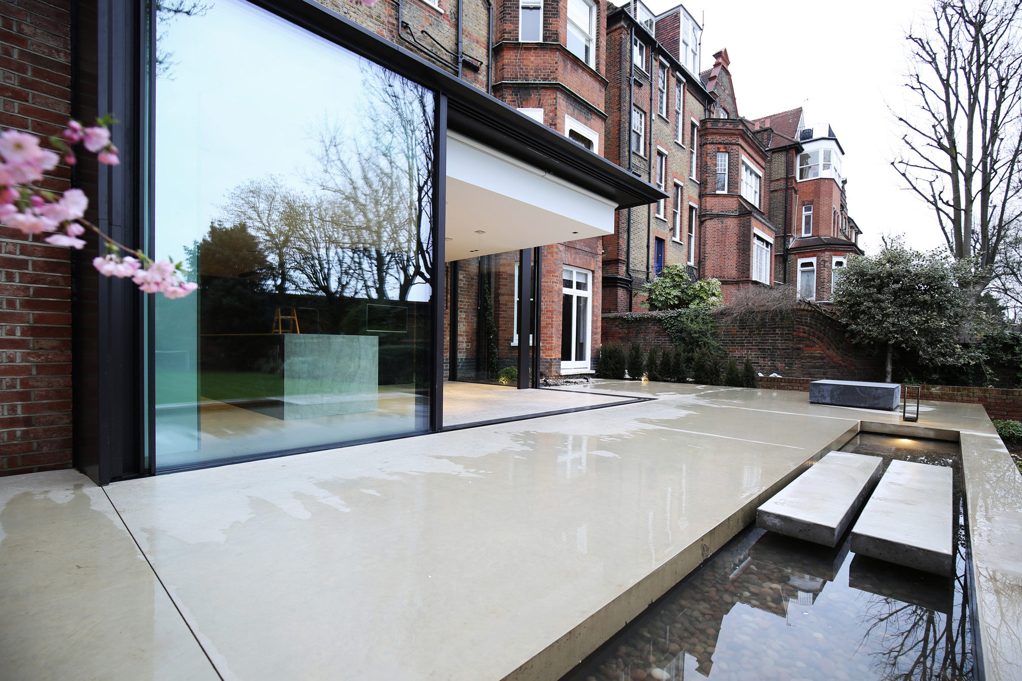 Glass windows and pond by LBMV Architects - luxury and modern architecture design studio in London