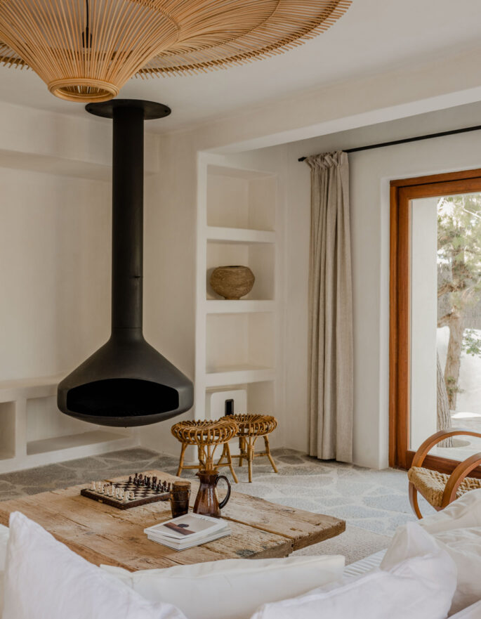 Ibiza Interiors contemporary and rustic interior design in Ibiza: Reception Room and suspended fireplace Cala Moli