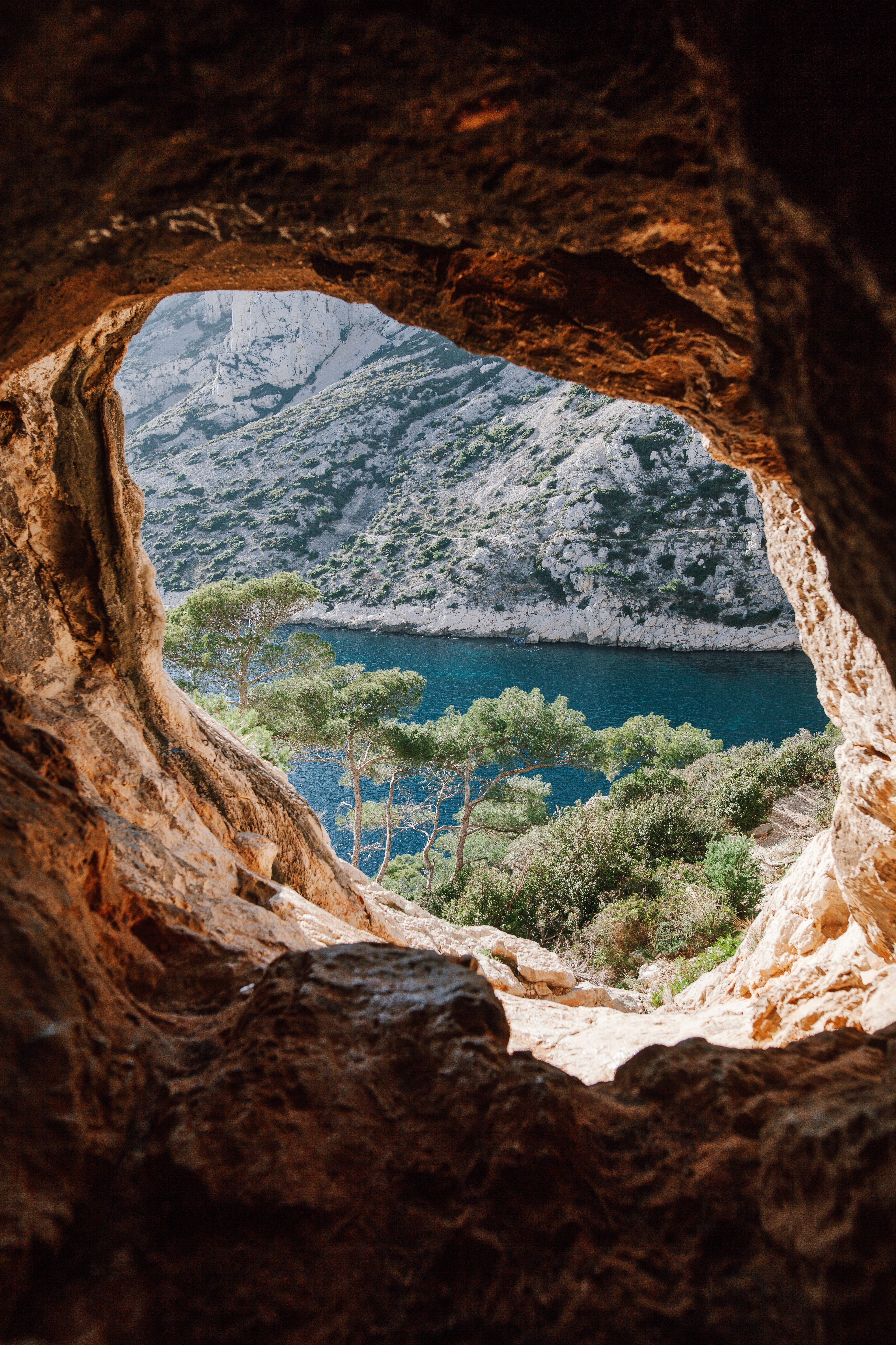 Looking out of a stone cove to the ocean in Greece, for Barnes International luxury real estate