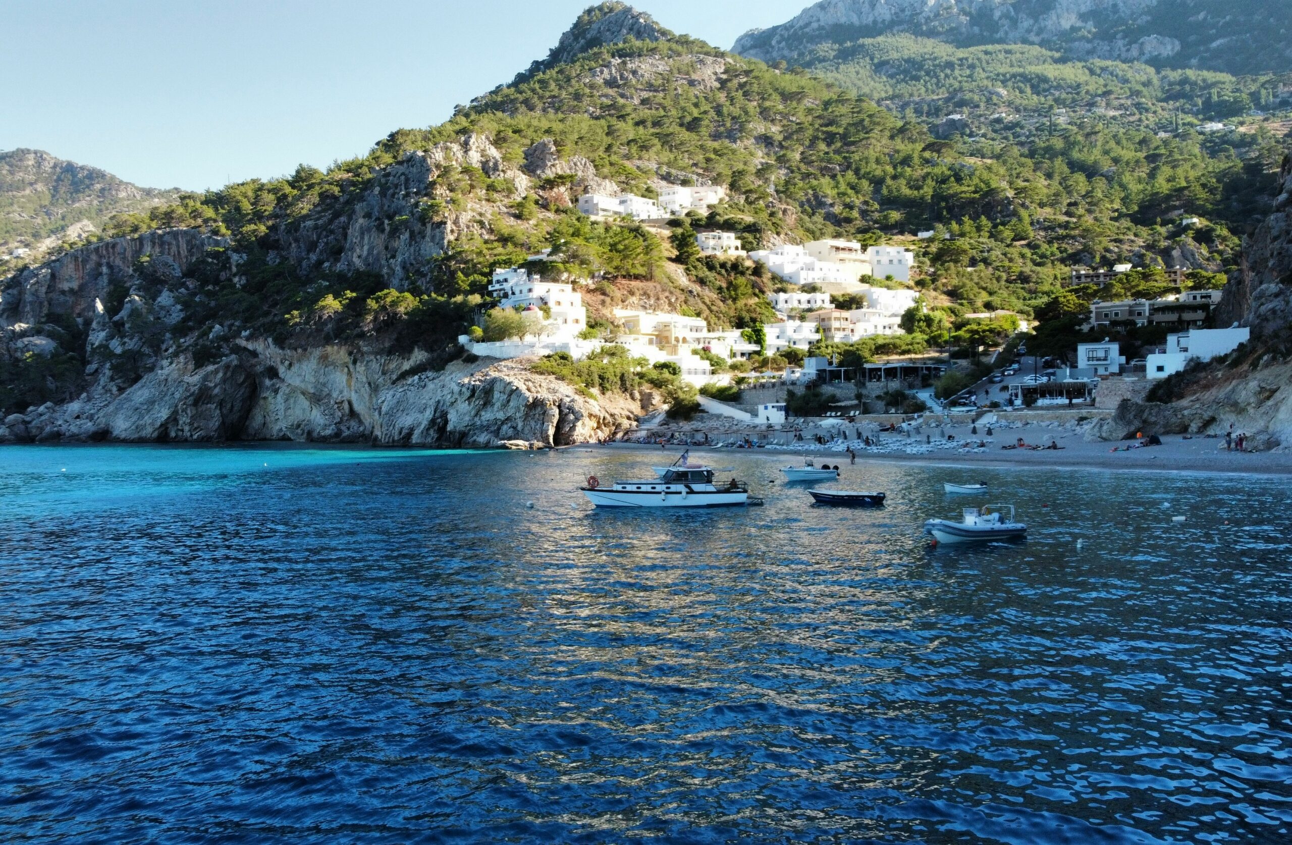 Boats on the water in Karpathos island in Greece, for Barnes International luxury real estate