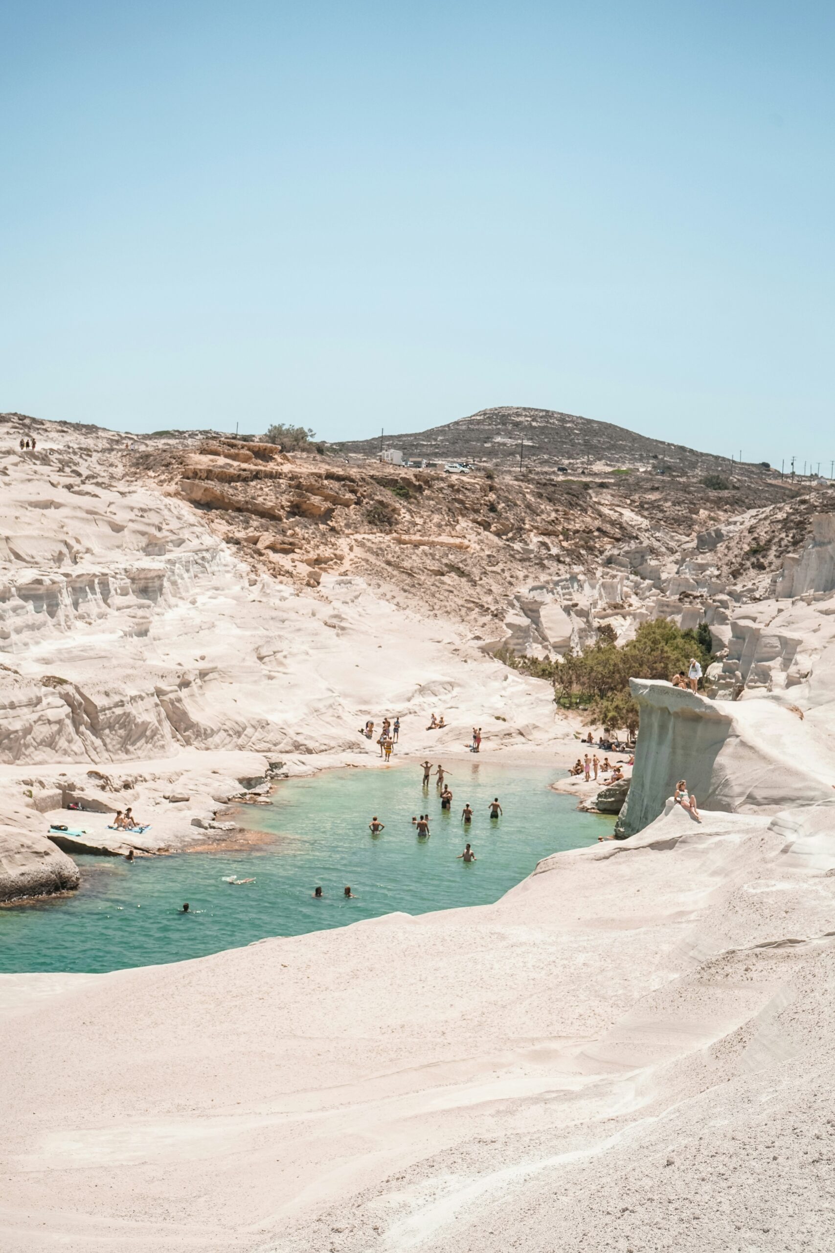 The white cliffs and blue waters of Sarakiniko Beach in Milos, for Barnes International luxury real estate