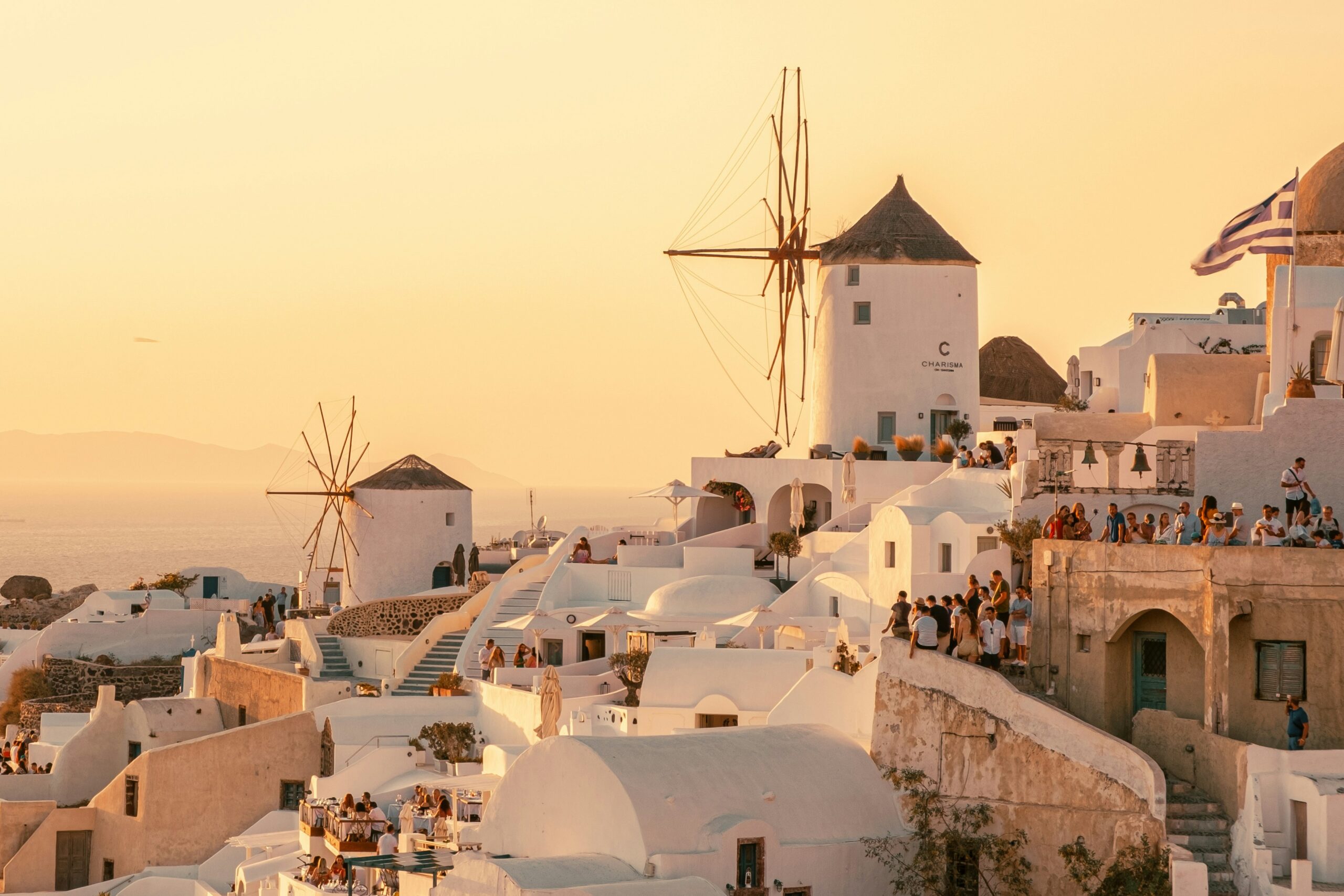 The windmills of Mykonos island in Greece against a sunset, for Barnes International luxury real estate