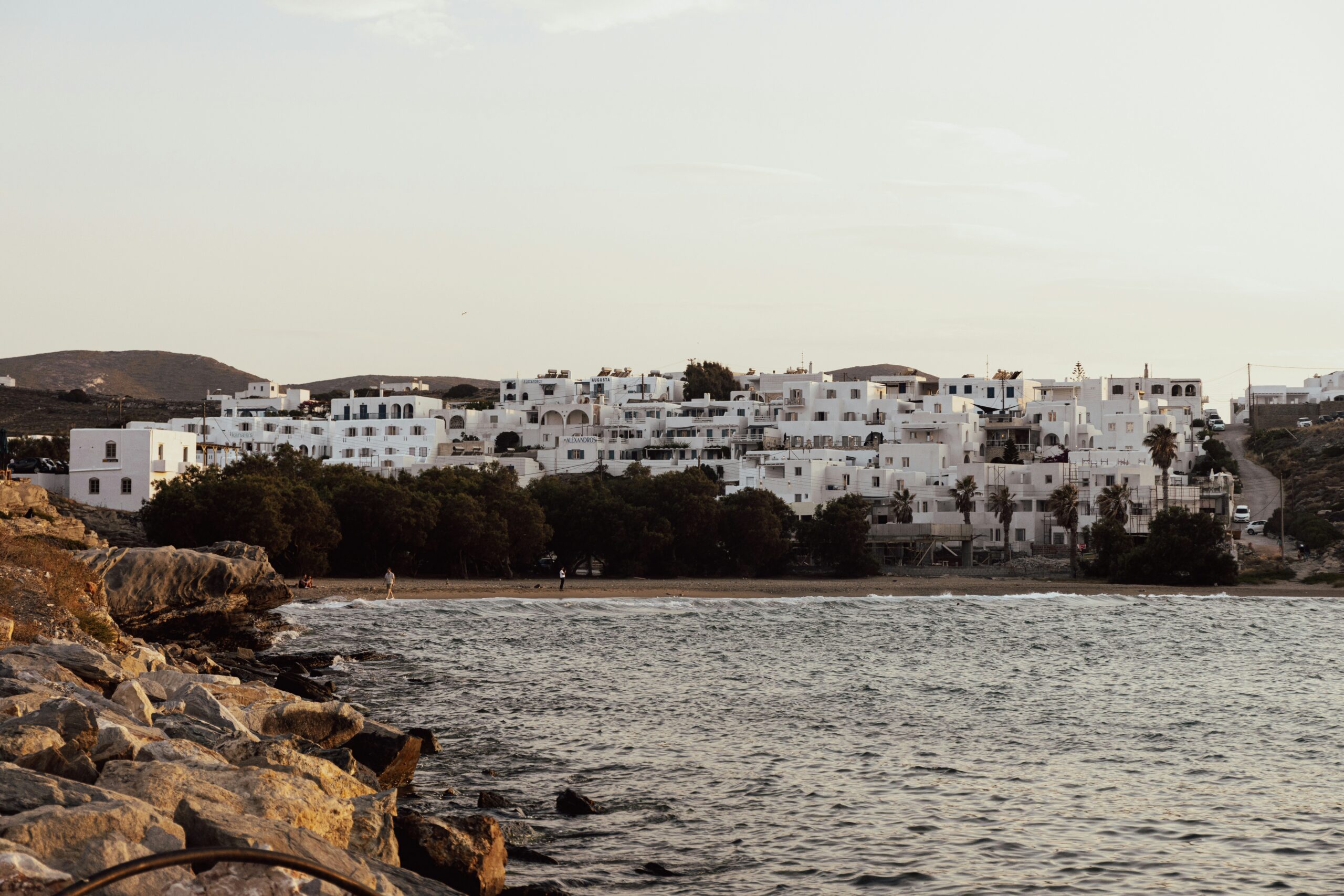 The sea and houses on land in Paros Greece, for Barnes International luxury real estate