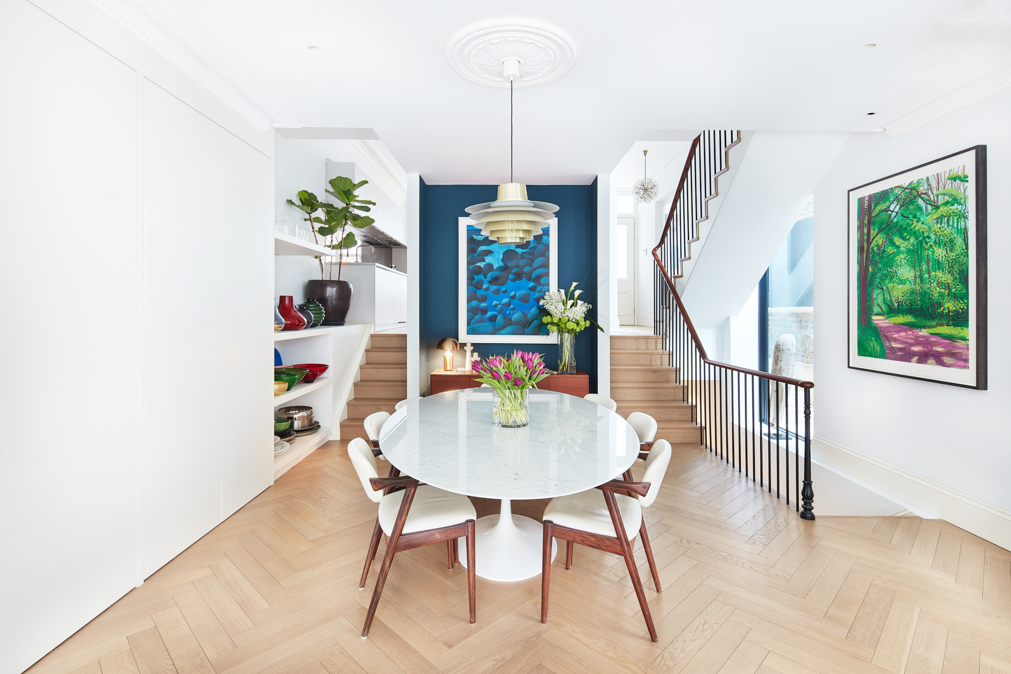 Whitewashed dining room of a design-led home