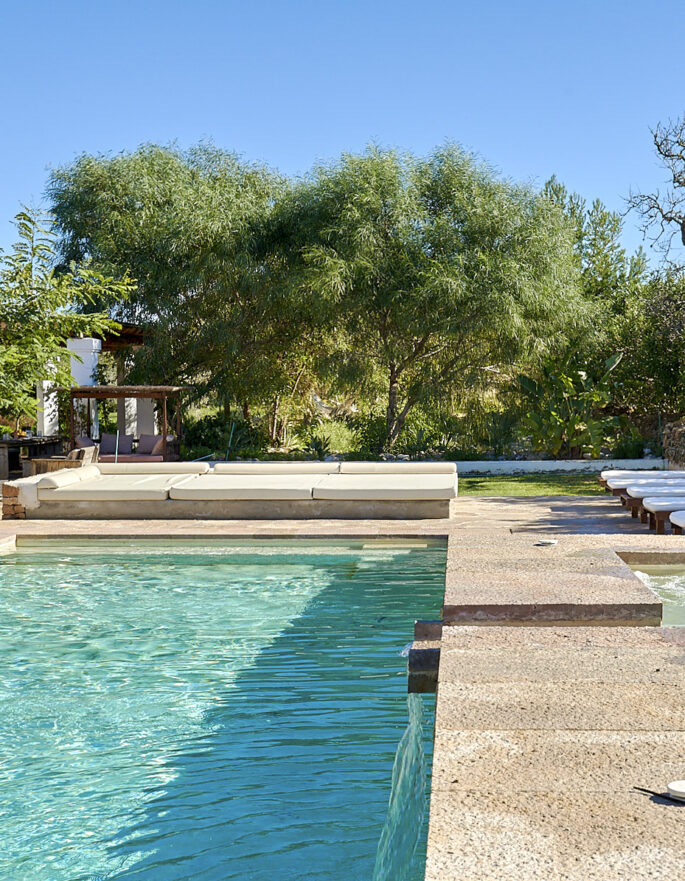 Poolside and treeline of a luxury villa in central Ibiza