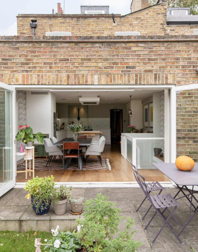 Glass doors opening to the private garden of a four-bedroom home for sale in Hammersmith