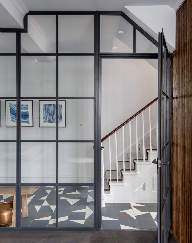 Reception enclosed behind a wall of Crittall glass in a four-bedroom home for sale in Hammersmith