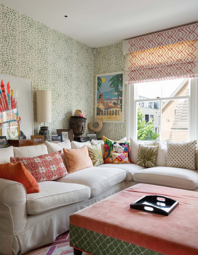 Kensington Park Road living room with pale sofa and patterned wallpaper by Barlow & Barlow