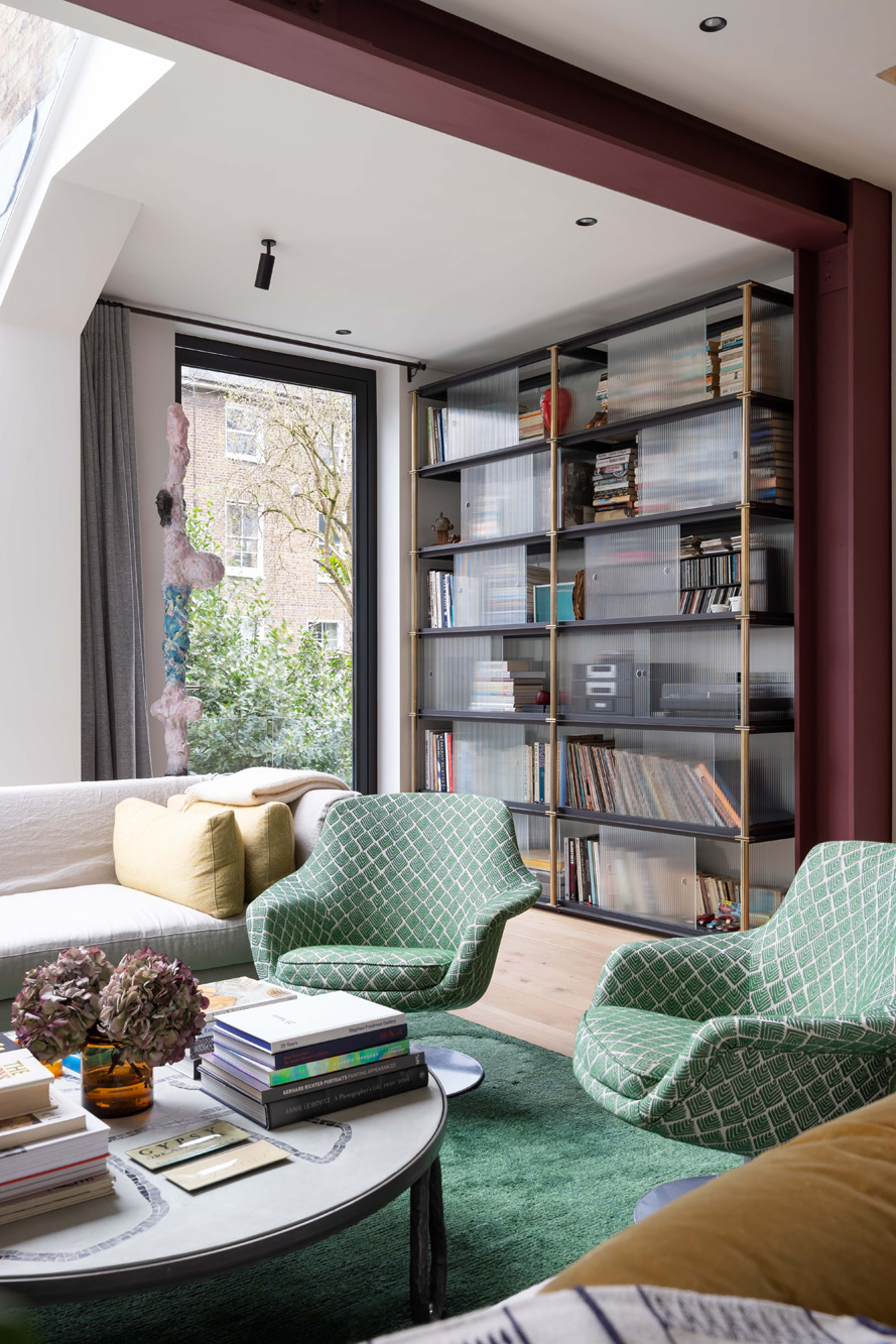 For Rent: Leamington Road Villas contemporary interior design with green armchairs and bookcase