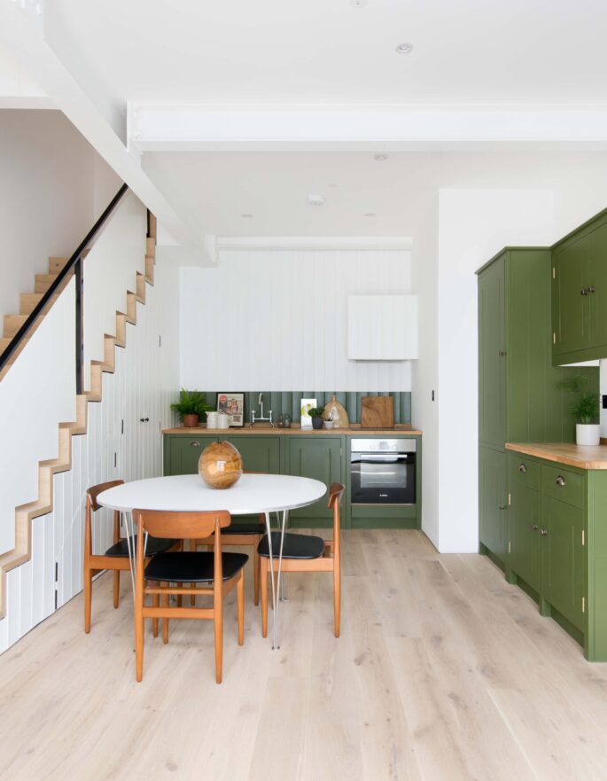 Godolphin Road open-plan kitchen and dining room with green cabinets and white walls