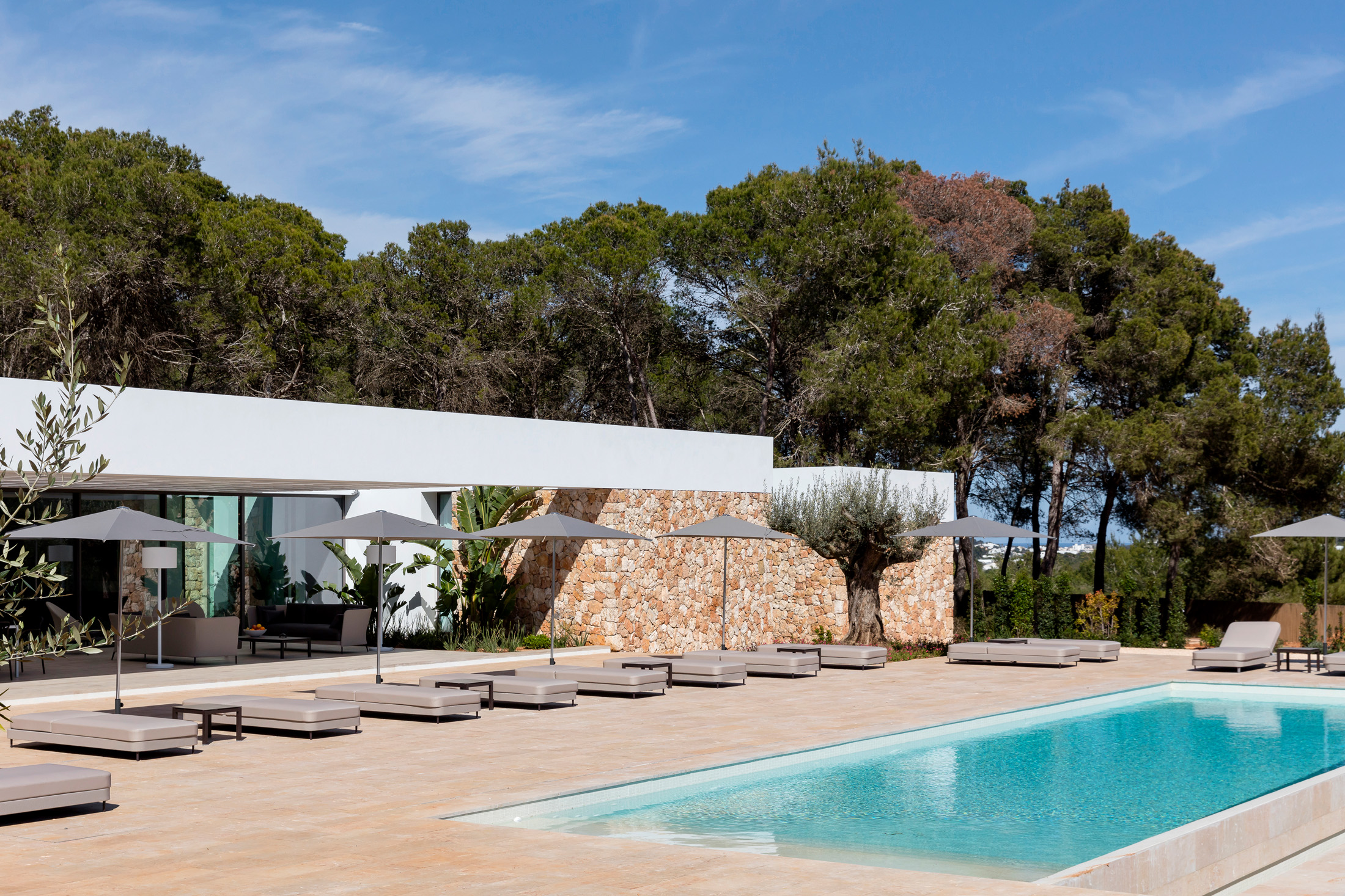Sun loungers next to a pool at an Ibiza rental villa