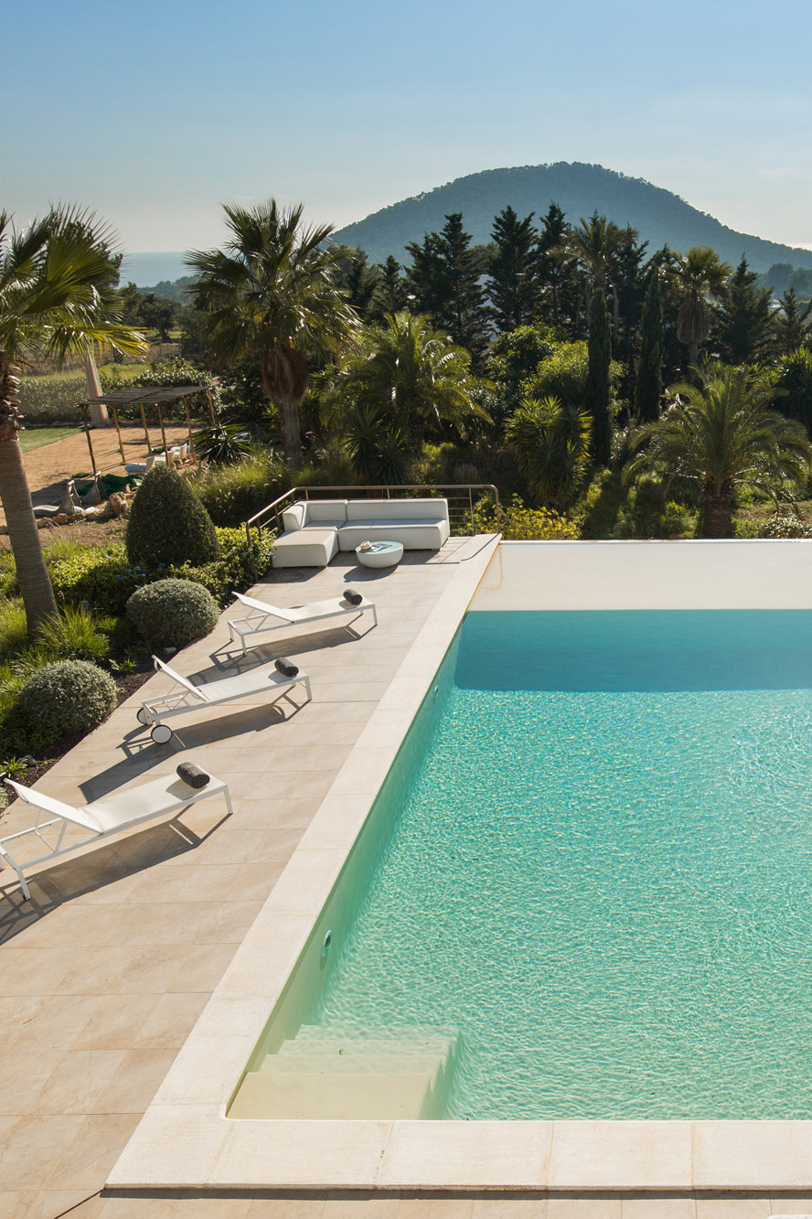 Pool furniture lays in the sun at a luxury rental villa in Ibiza