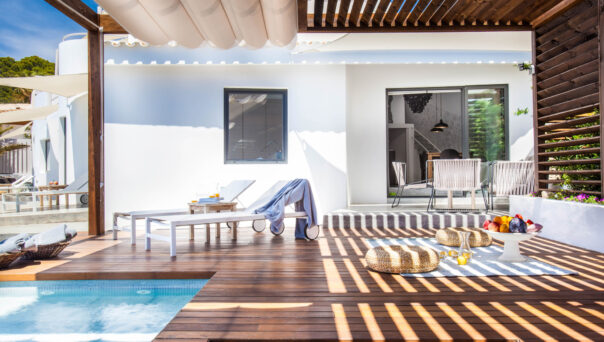 Slatted pergola provides shading across the deck of a luxury villa in Ibiza