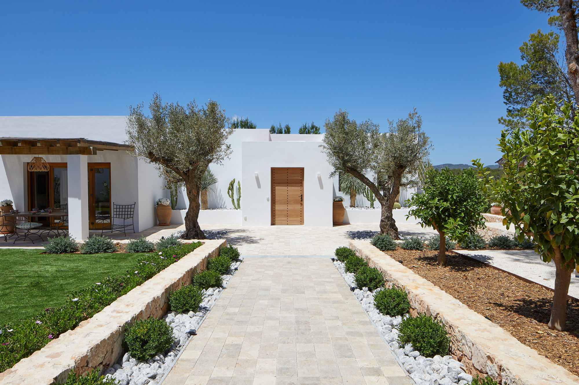 Symmetrical exterior entrance to a design-led rental villa in Ibiza