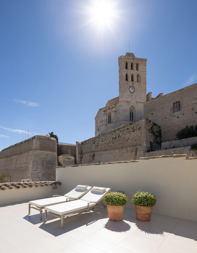 Sunny roof terrace of a luxury townhouse in Dalt Vila sits lower only than Catedral de Santa Maria in Ibiza