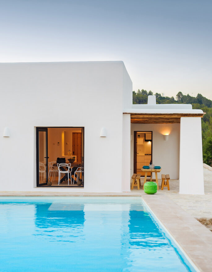Large pool and finca styling to the exterior of a rental villa in Ibiza