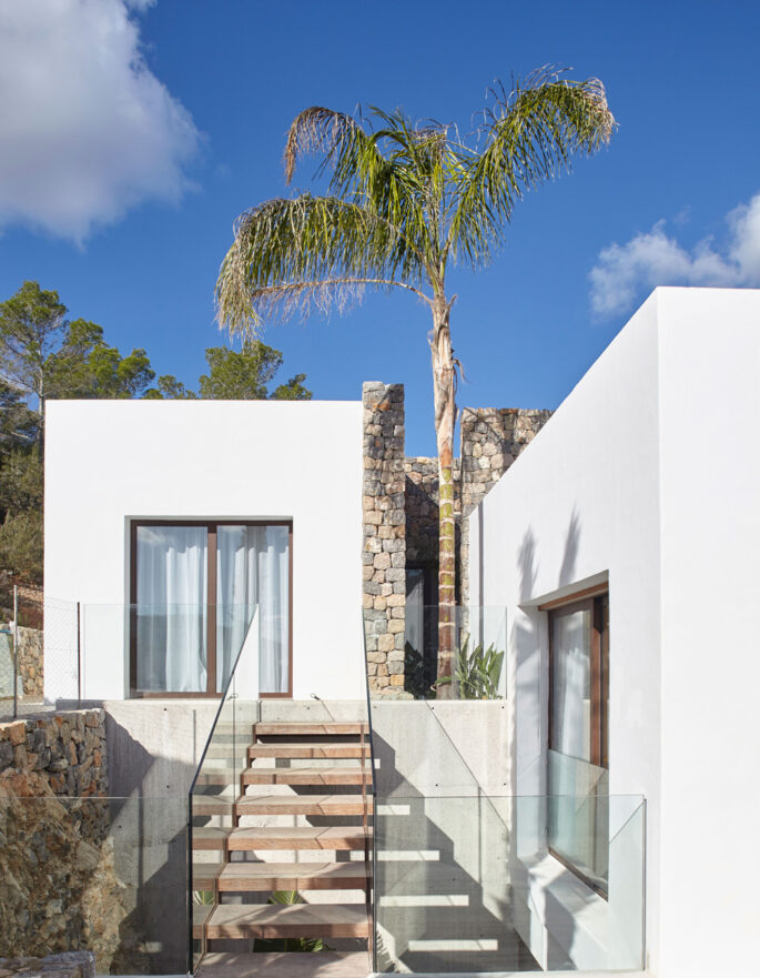 Steps appear to float above a void pulling natural light into a luxury villa in Ibiza
