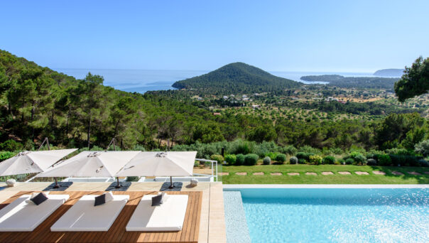 View over the pool and garden of a luxury villa to rent in southwest Ibiza