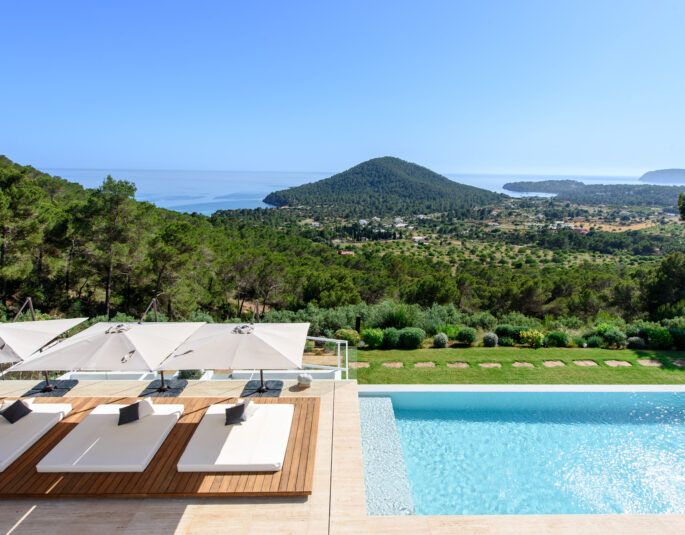 View over the pool and garden of a luxury villa to rent in southwest Ibiza