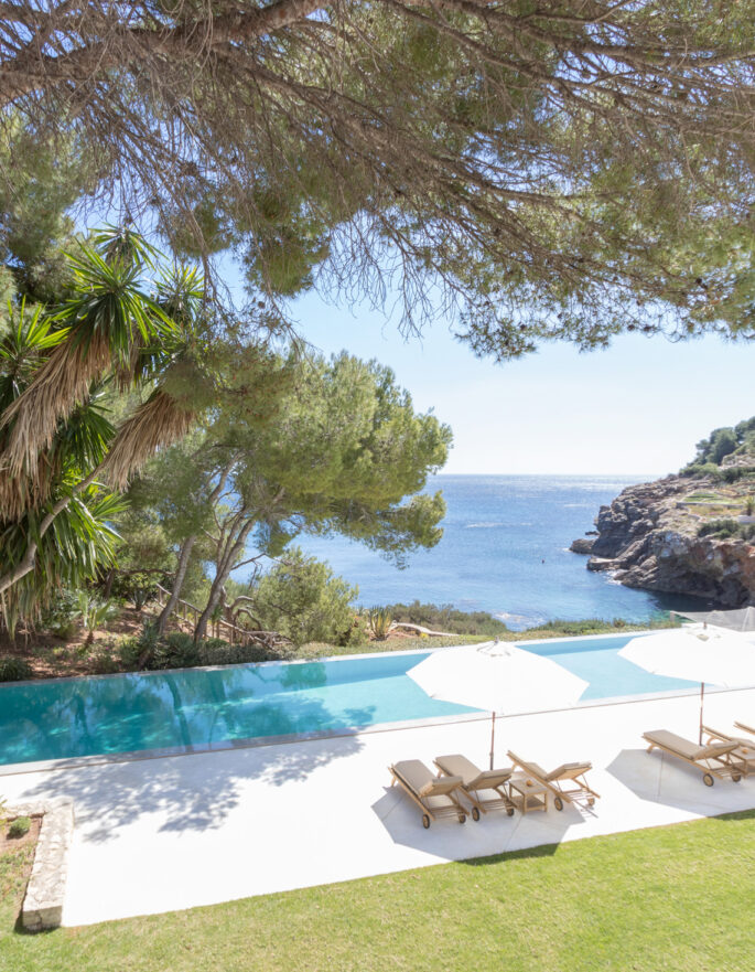 Trees shade the pool of a luxury holiday home on Ibiza