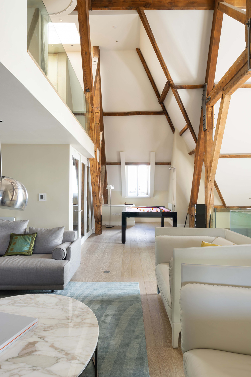St Pancras Penthouse by TG-Studio wooden rafters over the living room