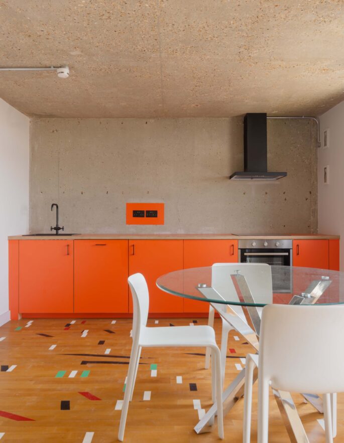For Rent: Trellick Tower North Kensington W10 brutalist interior design and modern kitchen with orange cabinets