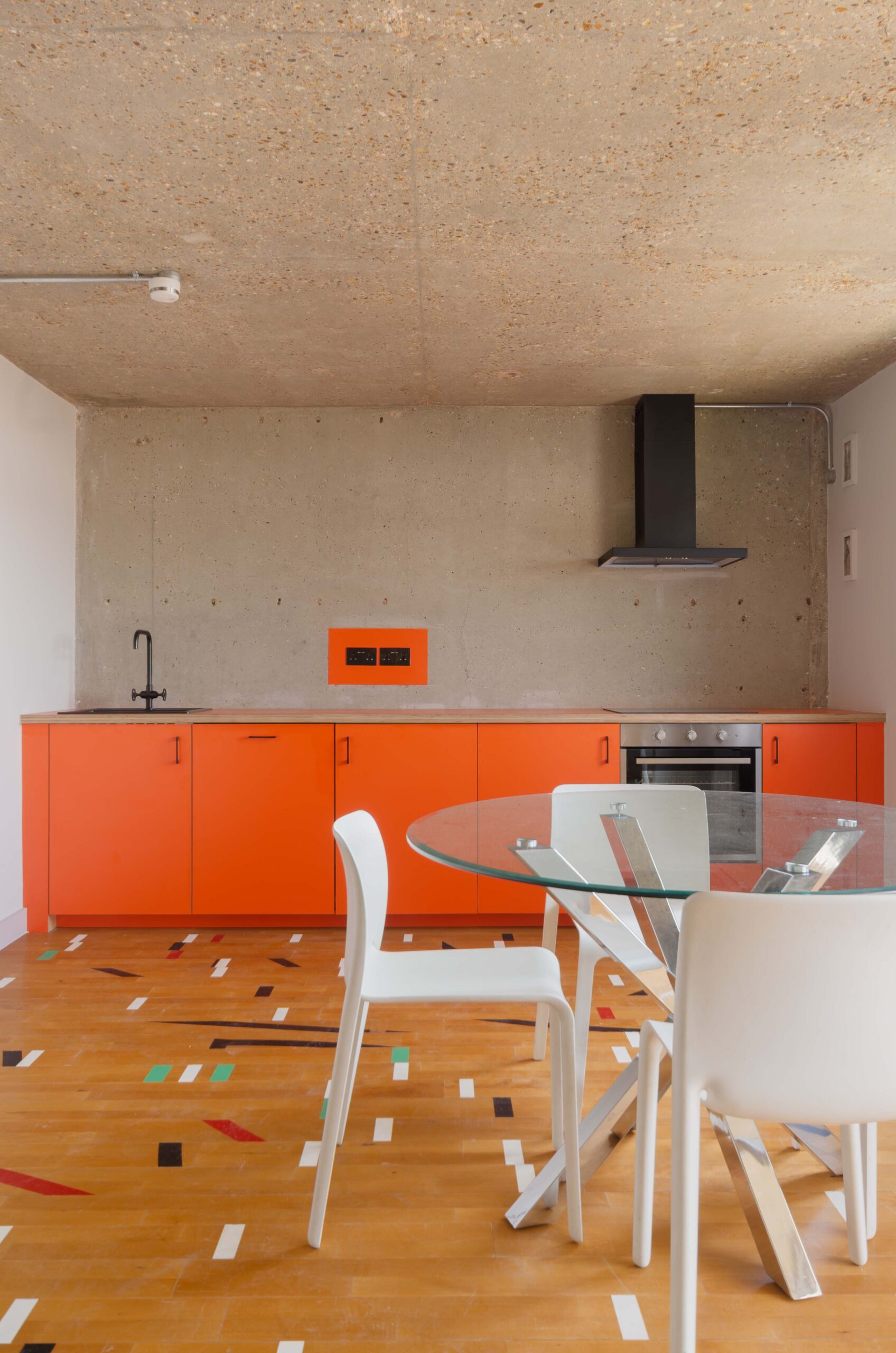 For Rent: Trellick Tower North Kensington W10 brutalist interior design and modern kitchen with orange cabinets