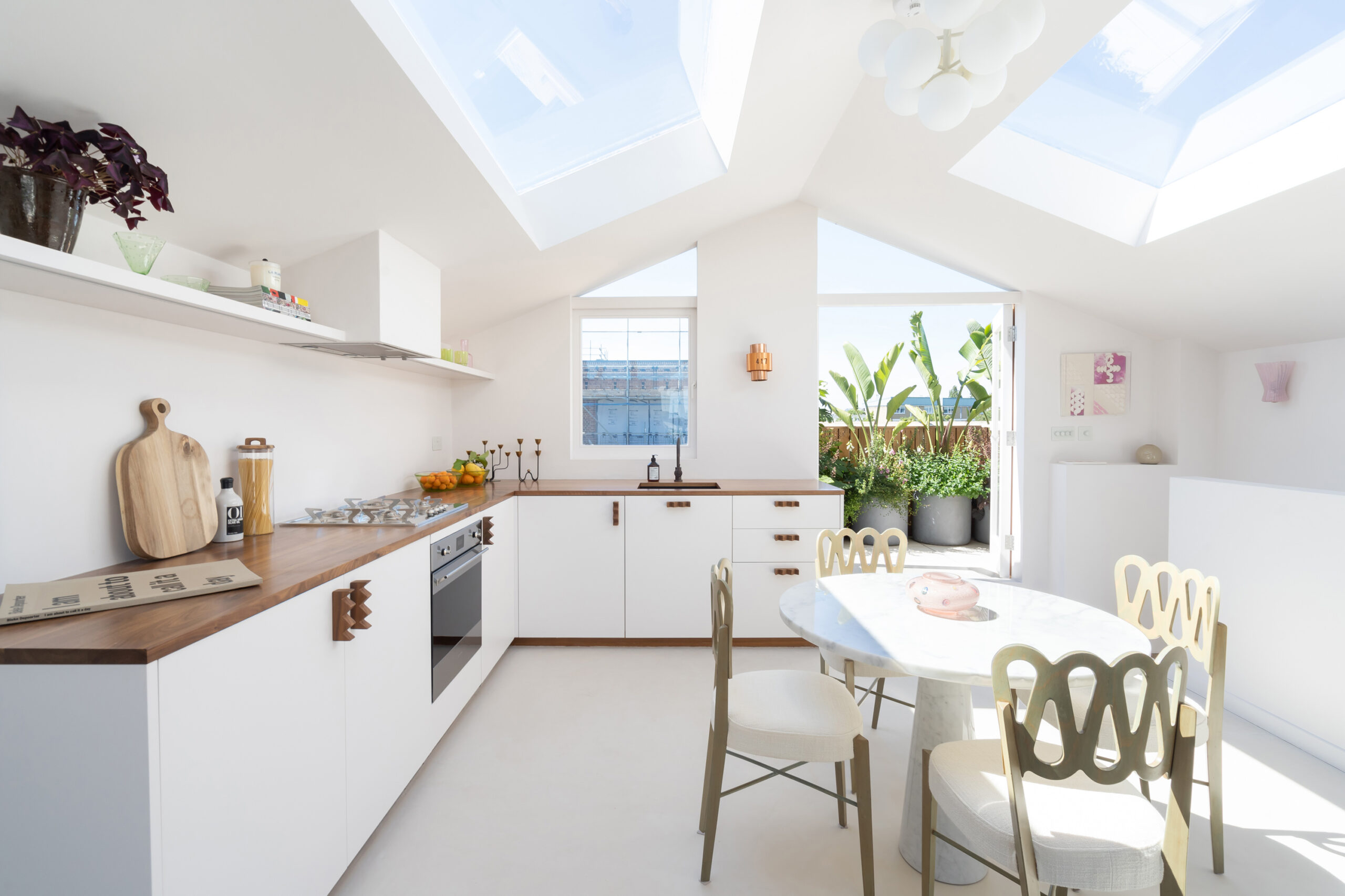 For Sale: Golborne Road North Kensington W10 top-floor kitchen with minimalist furniture and skylights