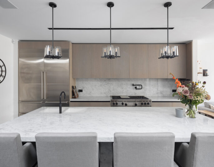 A kitchen with a large marble island