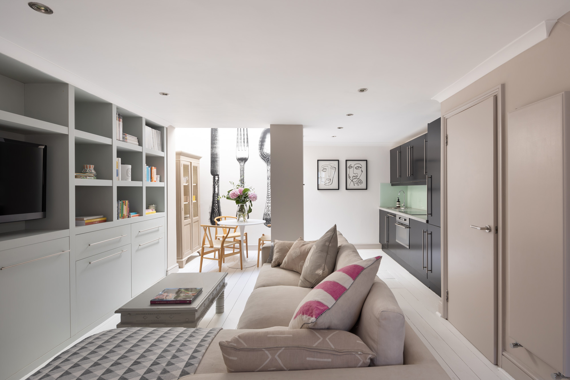 For sale, Pottery Lane London Holland Park W11 living room with shelving and sofas