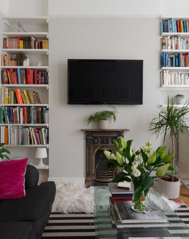 For Sale: Westbourne Park Road Notting Hill W11 modern reception room with bookcases and stylish furniture