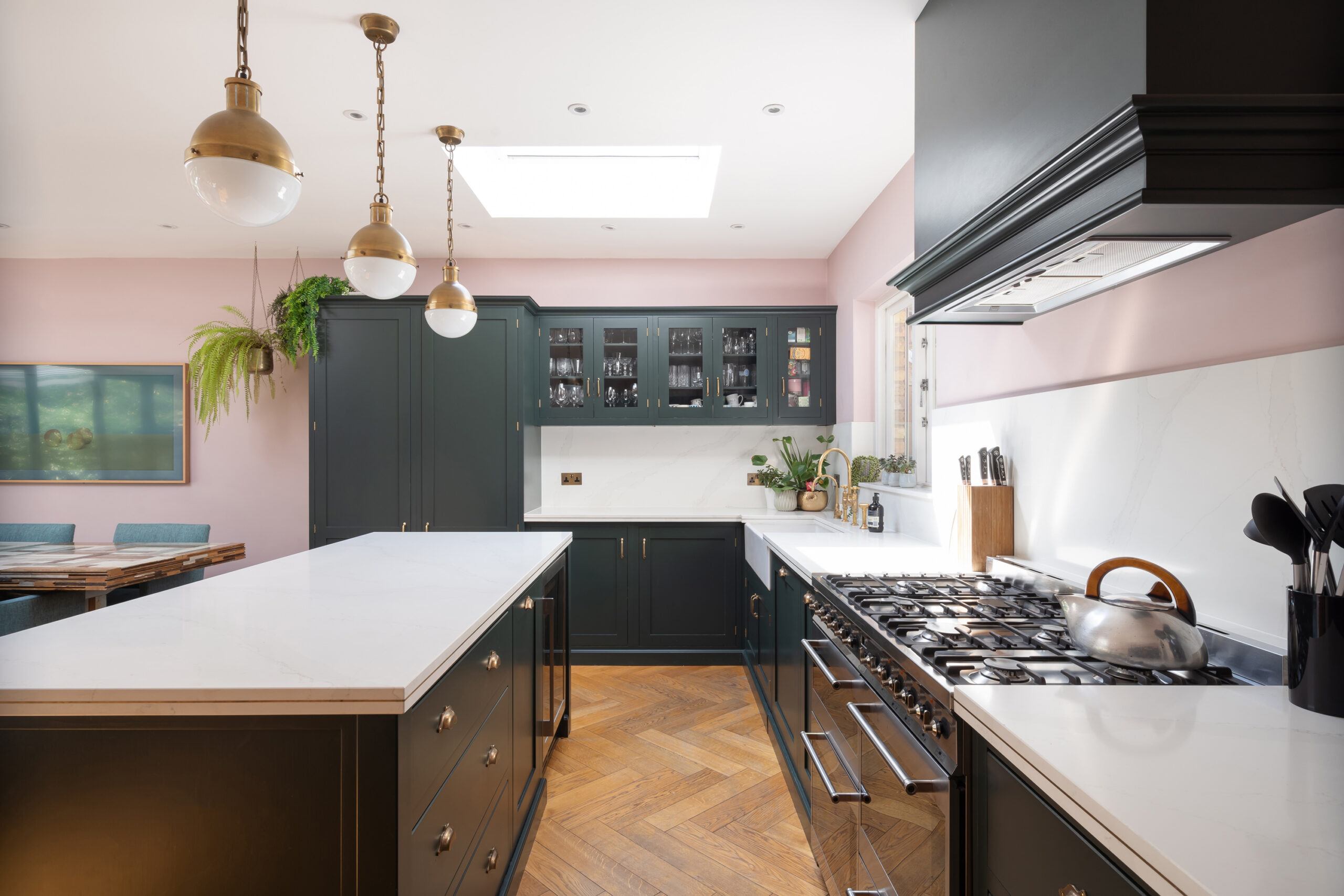 A striking and playful pink and green kitchen