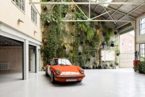 Porsche 911 backdropped by a living wall in a unique luxury property for sale in Gladstone Park