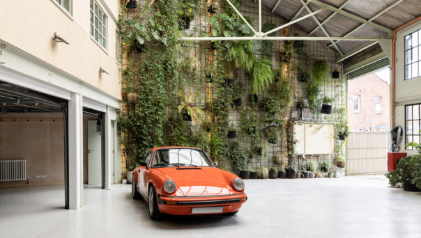 Porsche 911 backdropped by a living wall in a unique luxury property for sale in Gladstone Park