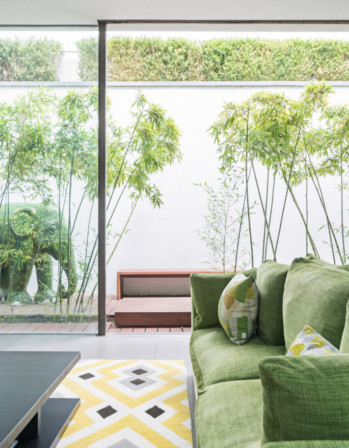 For Rent: Portland Road Notting Hill Holland Park W11 green sofa and glass windows onto the garden