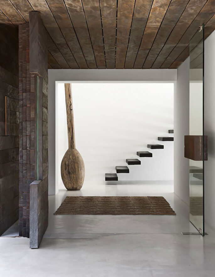 Staircase through wood door by luxury architecture studio in Ibiza De Castro Arquitectos
