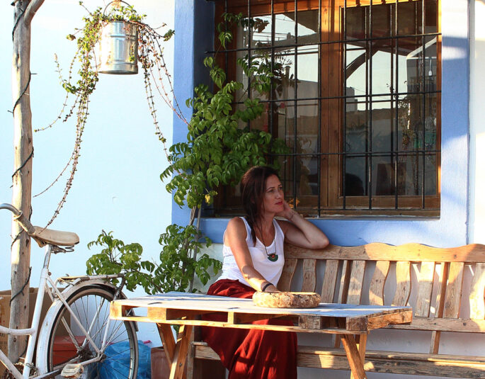 Young beautiful woman sits in terrace on Formentera Bar