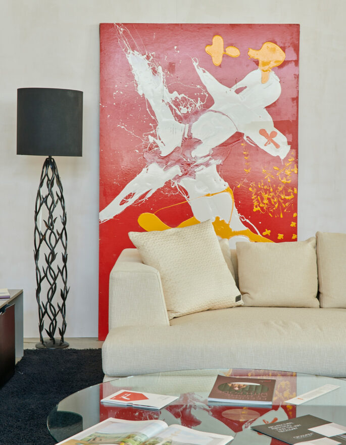 Red artwork and sofa by Ibermaison - luxury interior design and furniture in Ibiza