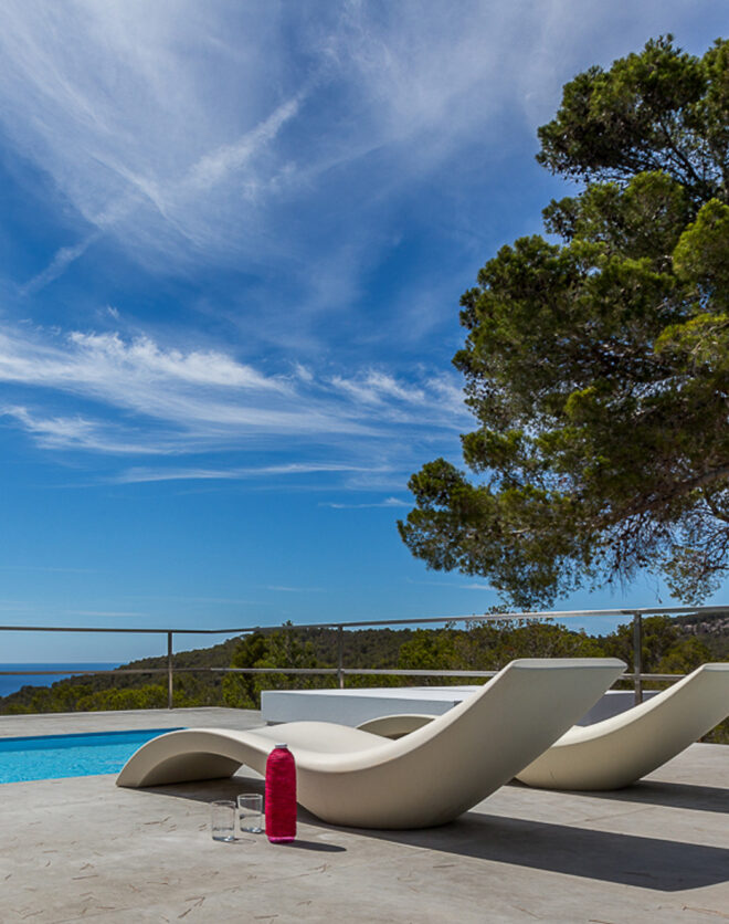 Richard Schultz sun loungers lay next to the pool of a private rental villa in Ibiza