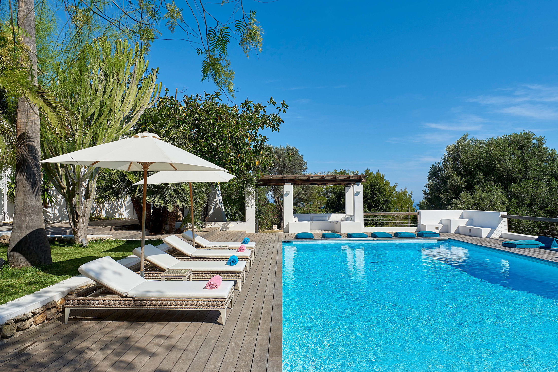 Sun loungers by a pool at a villa in Ibiza
