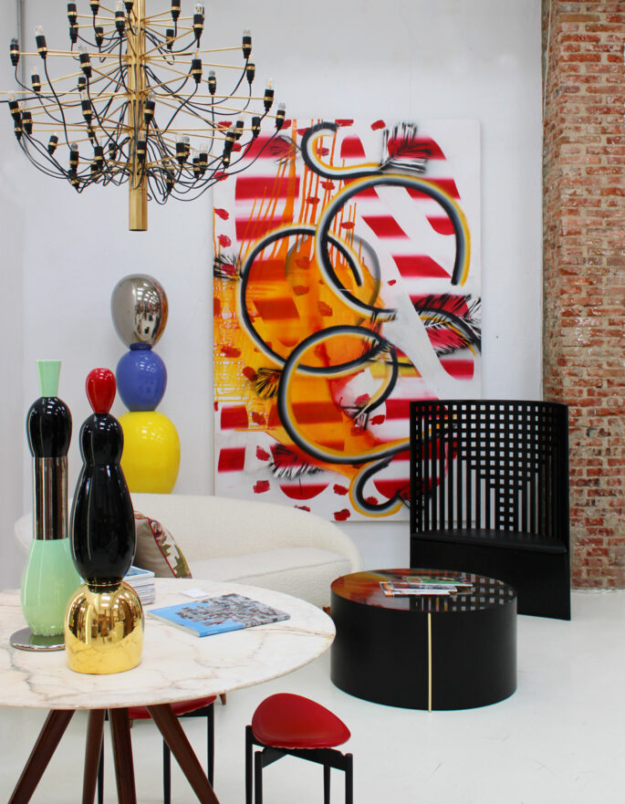 An eclectic mix of artwork including a graffiti canvas by LA Studio, modern interior design and furniture in Ibiza