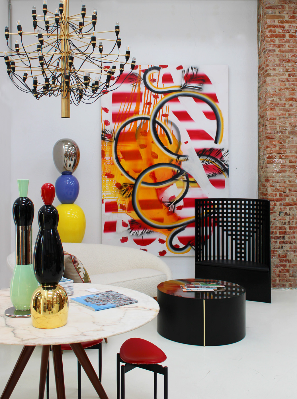 An eclectic mix of artwork including a graffiti canvas by LA Studio, modern interior design and furniture in Ibiza