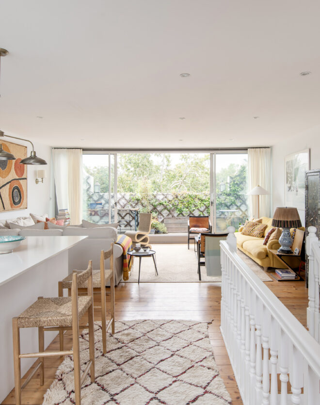 Bright open-plan living room with bi-folding doors to balcony in a luxury three-bedroom duplex for sale in North Kensington