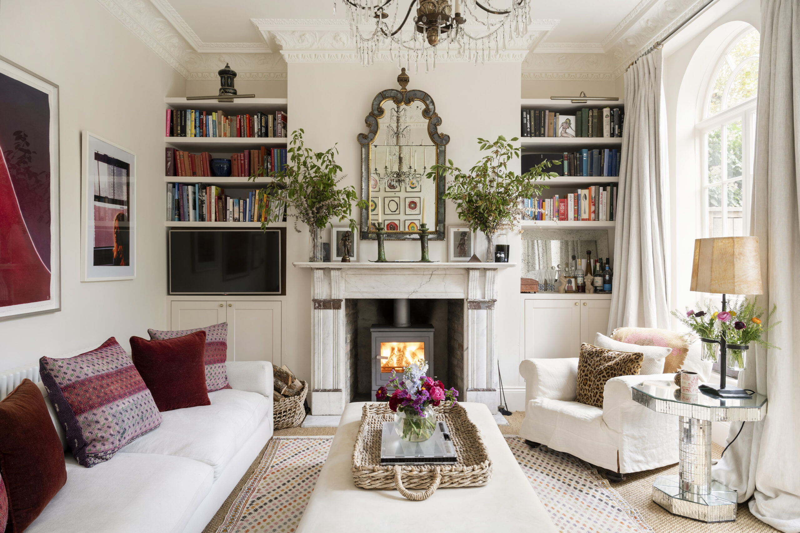 Elegant reception room with fireplace of a three-bedroom maisonette for sale in Queen's Park
