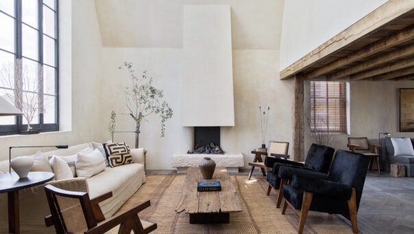 Double-height proportions characterise the rustic-luxe living room of a penthouse apartment for rent in Notting Hill