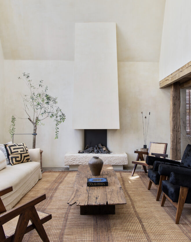 Double-height proportions characterise the rustic-luxe living room of a penthouse apartment for rent in Notting Hill