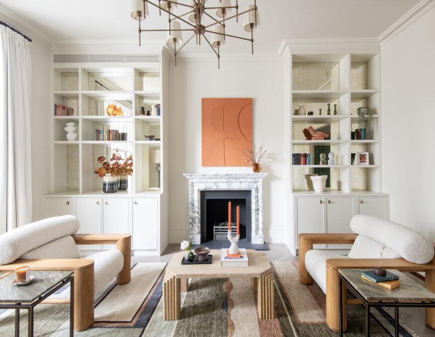 Luxury reception room with integrated bookshelves and marble fireplace in a three-bedroom Notting Hill duplex apartment for sale