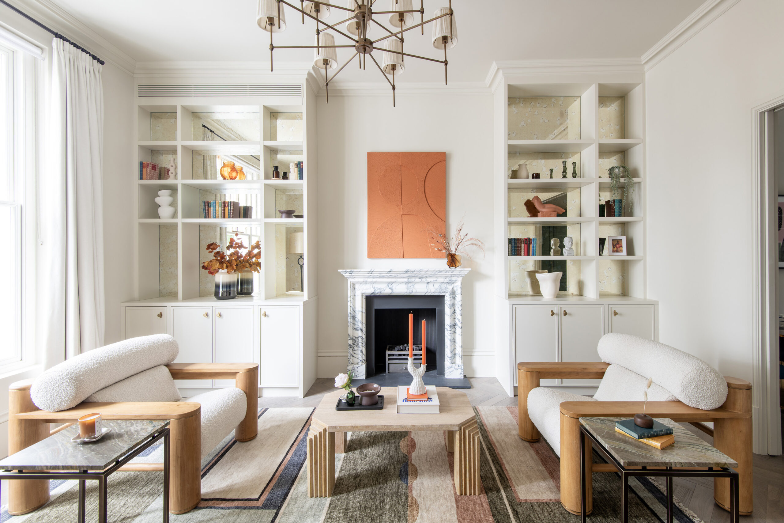 Luxury reception room with integrated bookshelves and marble fireplace in a three-bedroom Notting Hill duplex apartment for sale