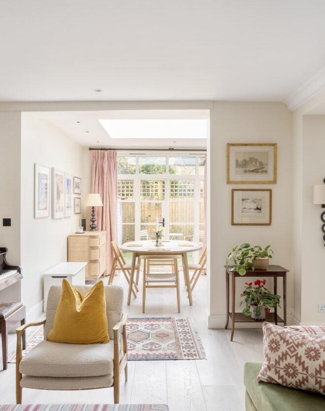 Reception room with french doors leading to a leafy garden in a three-bedroom apartment for sale