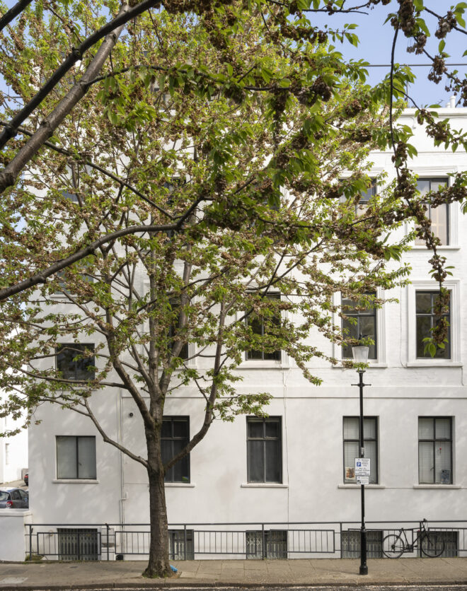 Traditional stucco exterior of a luxury apartment for sale in North Kensington
